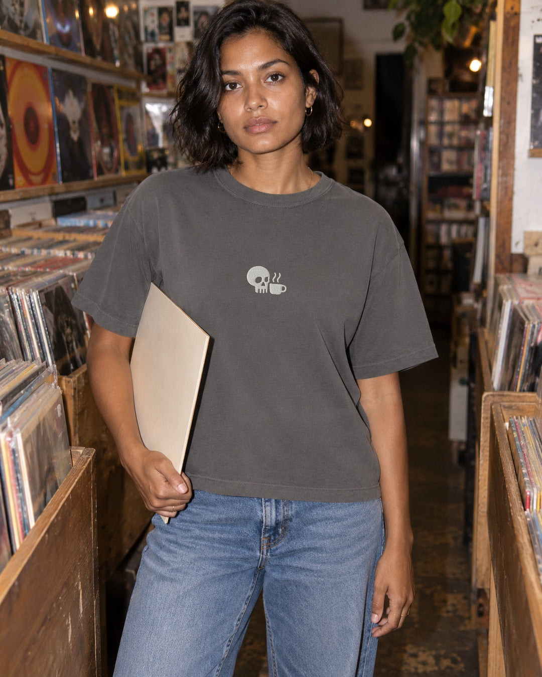 Editorial study of the gray SDC signature tee worn while browsing records